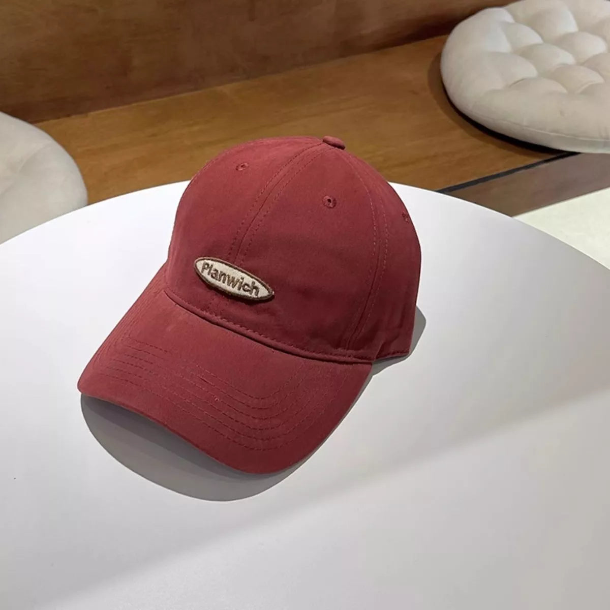 Close detail of the embroidered oval patch on the cap