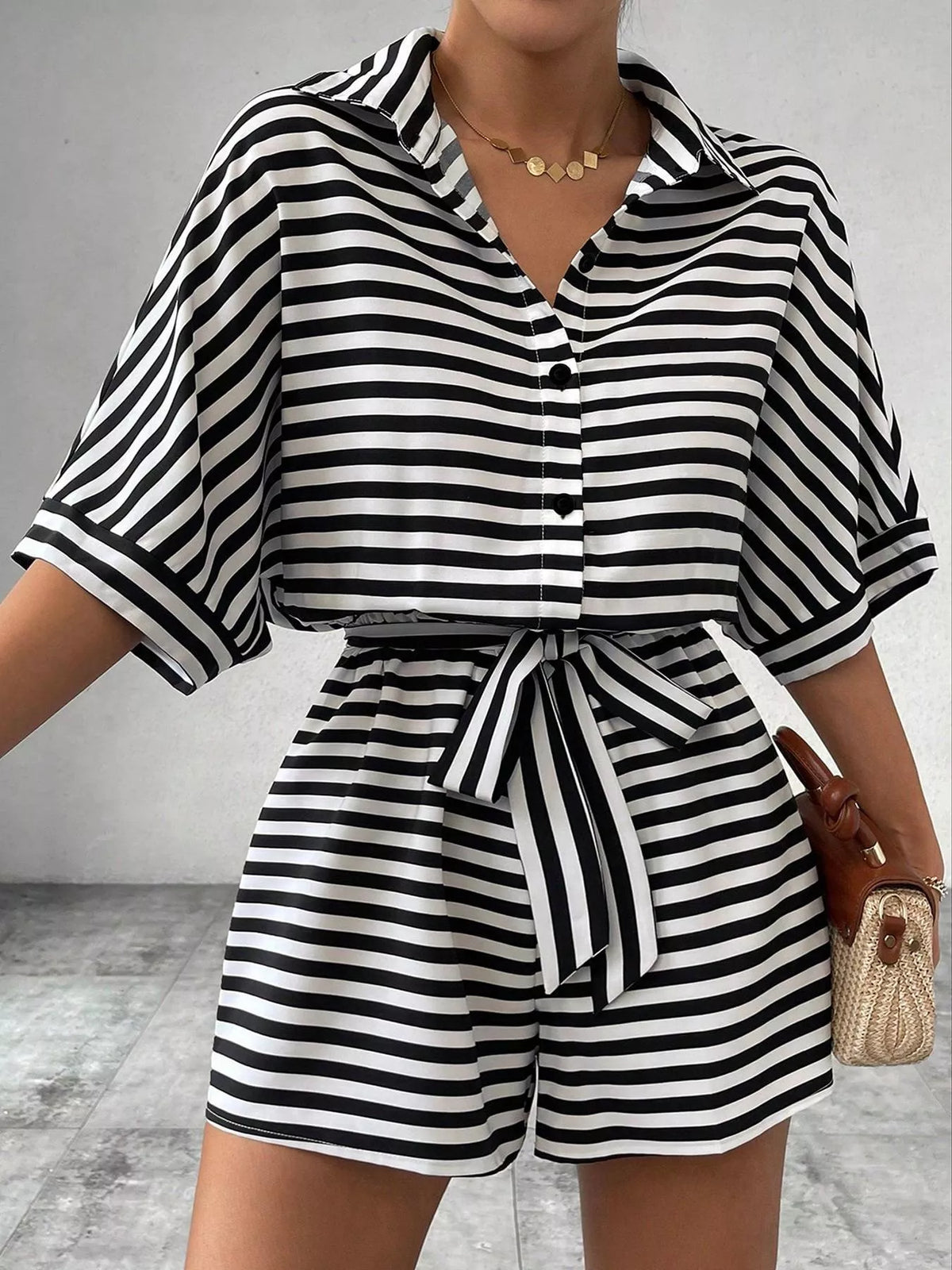 Detail of button front and belt on striped romper