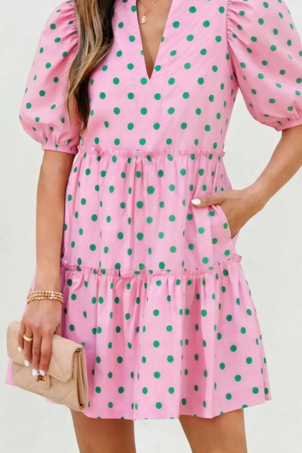 Blush pink polka dot tiered mini dress side view