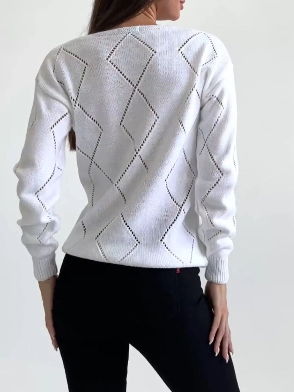 White V neck sweater styled with trousers
