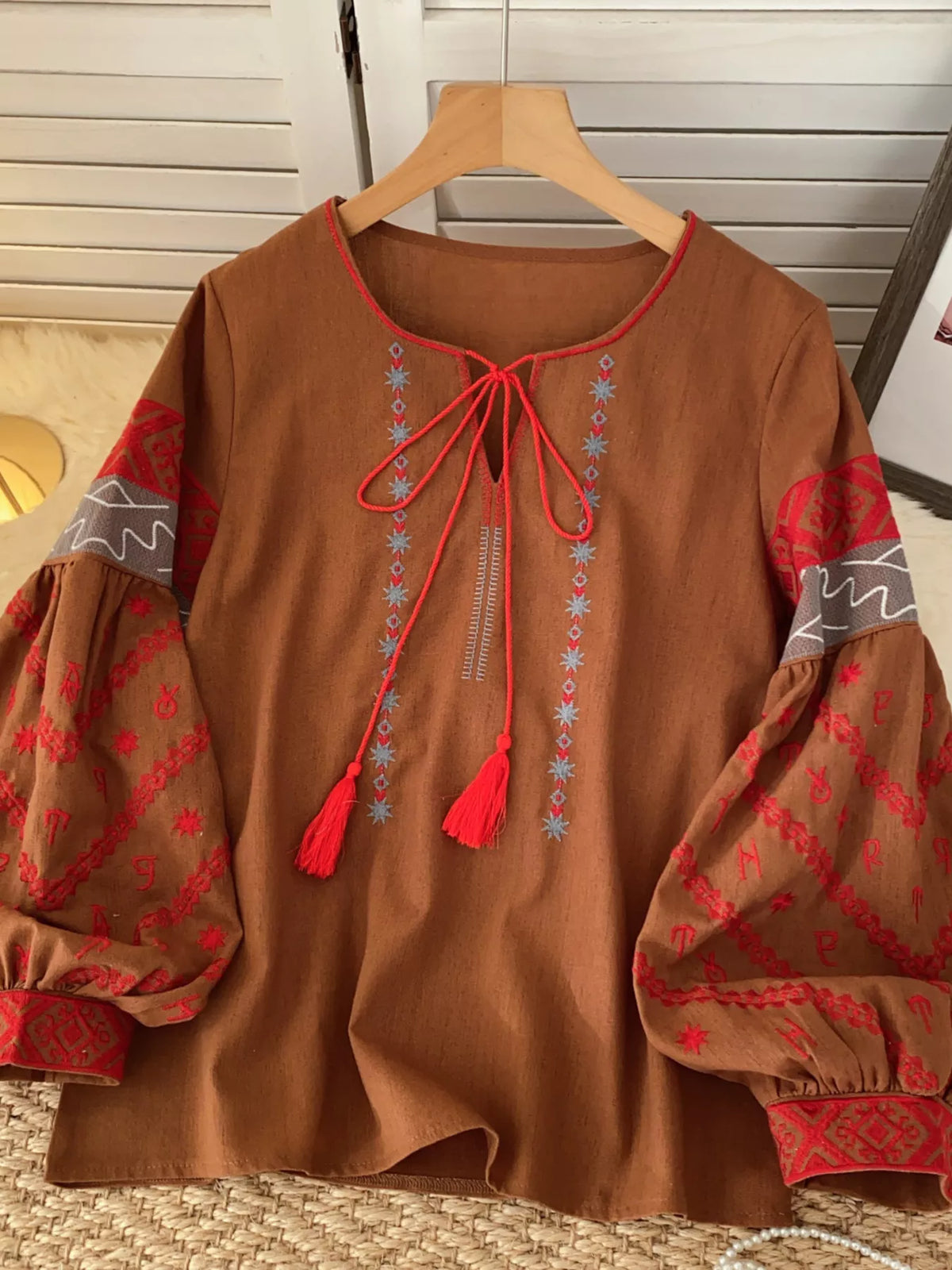 Embroidered tie neck blouse on model