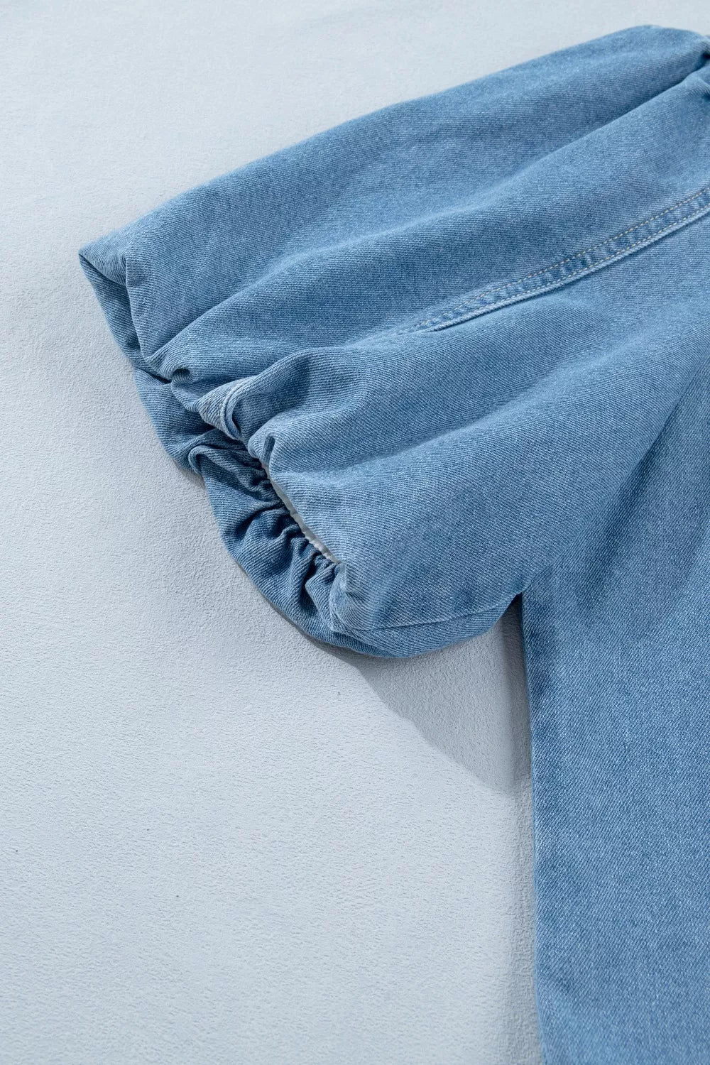 light wash puff sleeve ruffle hem denim dress sleeve detail