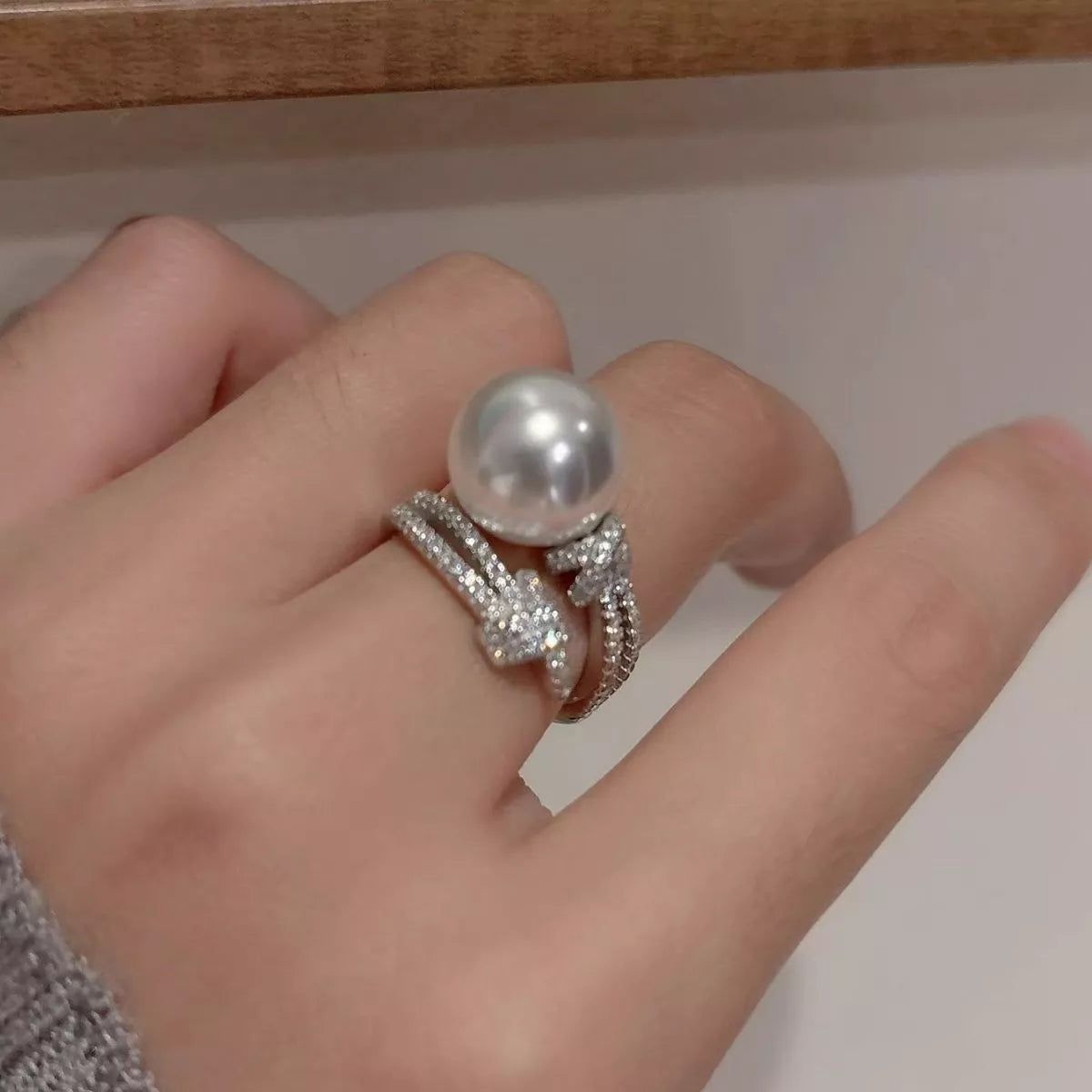 pearl and zircon bypass ring in sterling silver flat lay detail