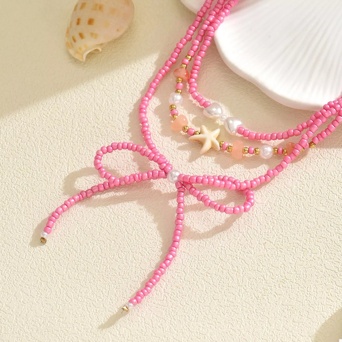 Fashorio Fuchsia Pink / onesize Beaded Three-Layered Necklace with Bow and Starfish Charms