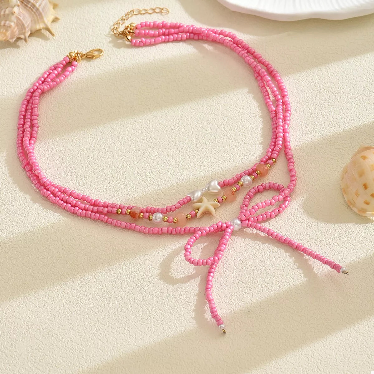 Fashorio Fuchsia Pink / onesize Beaded Three-Layered Necklace with Bow and Starfish Charms