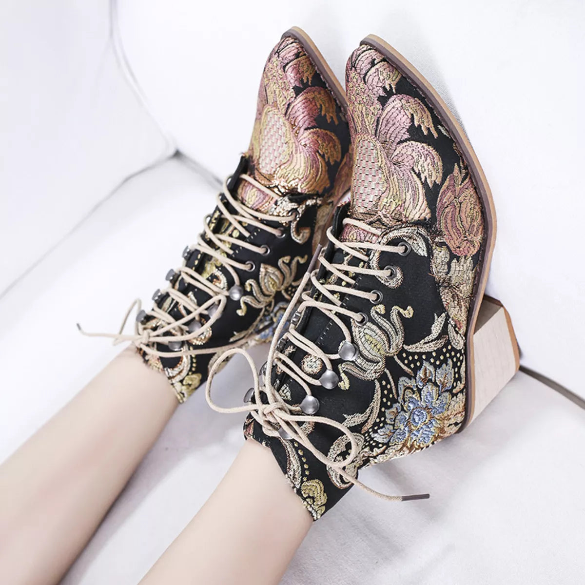 Gold embroidered floral lace up ankle boots angled three quarter view