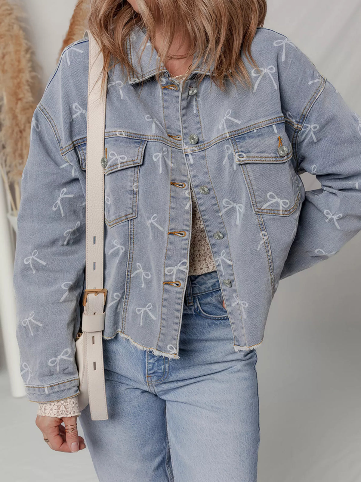 Bow Print Raw Hem Denim Jacket in Light Wash side view