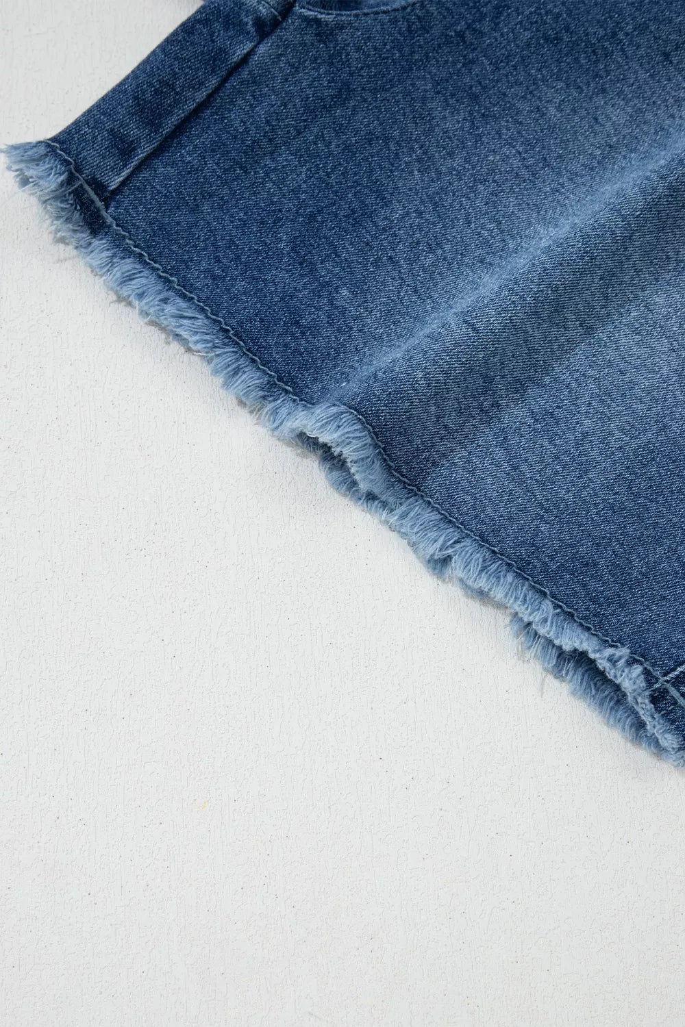 Medium wash wrapped tie waist denim skort full length view