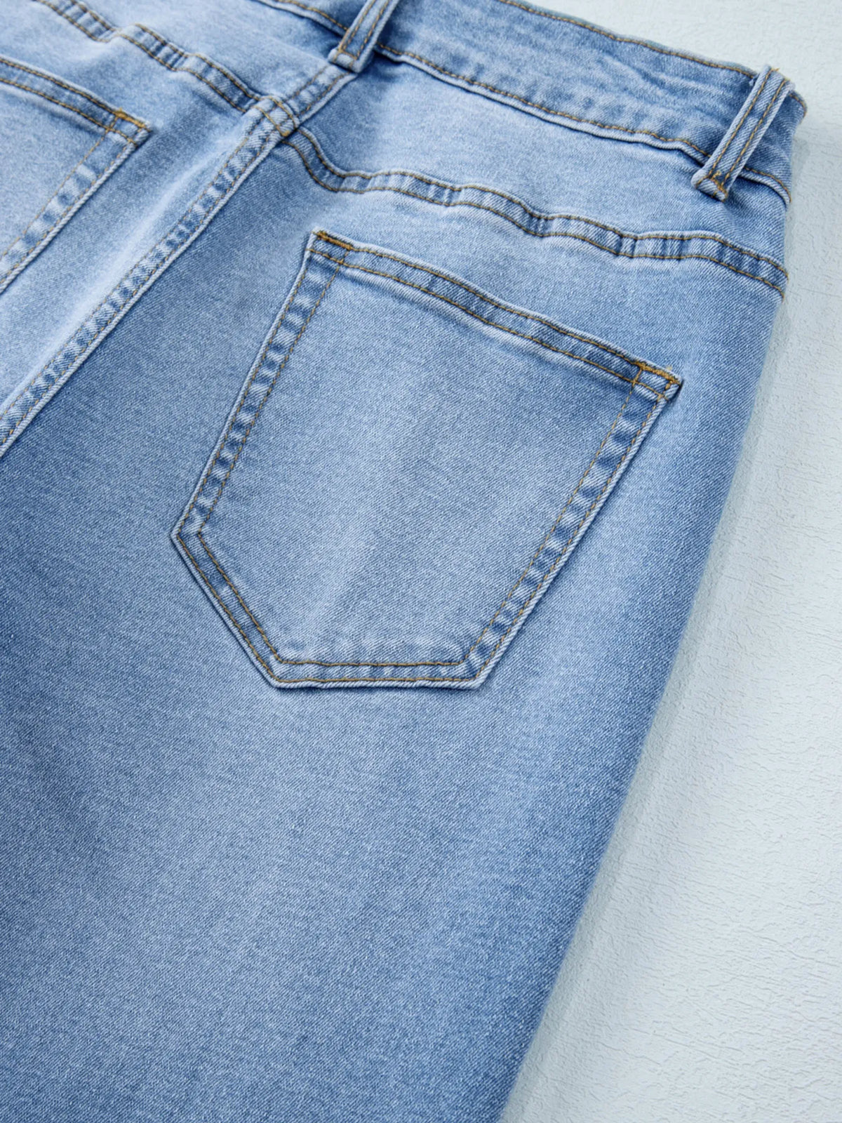 Back detail of washed wide leg jeans
