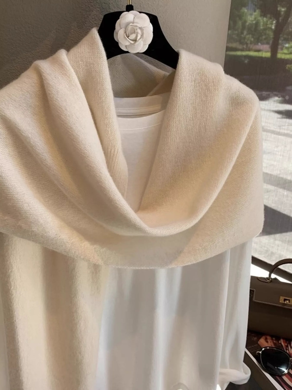 Wool knitted asymmetrical shawl over the shoulders