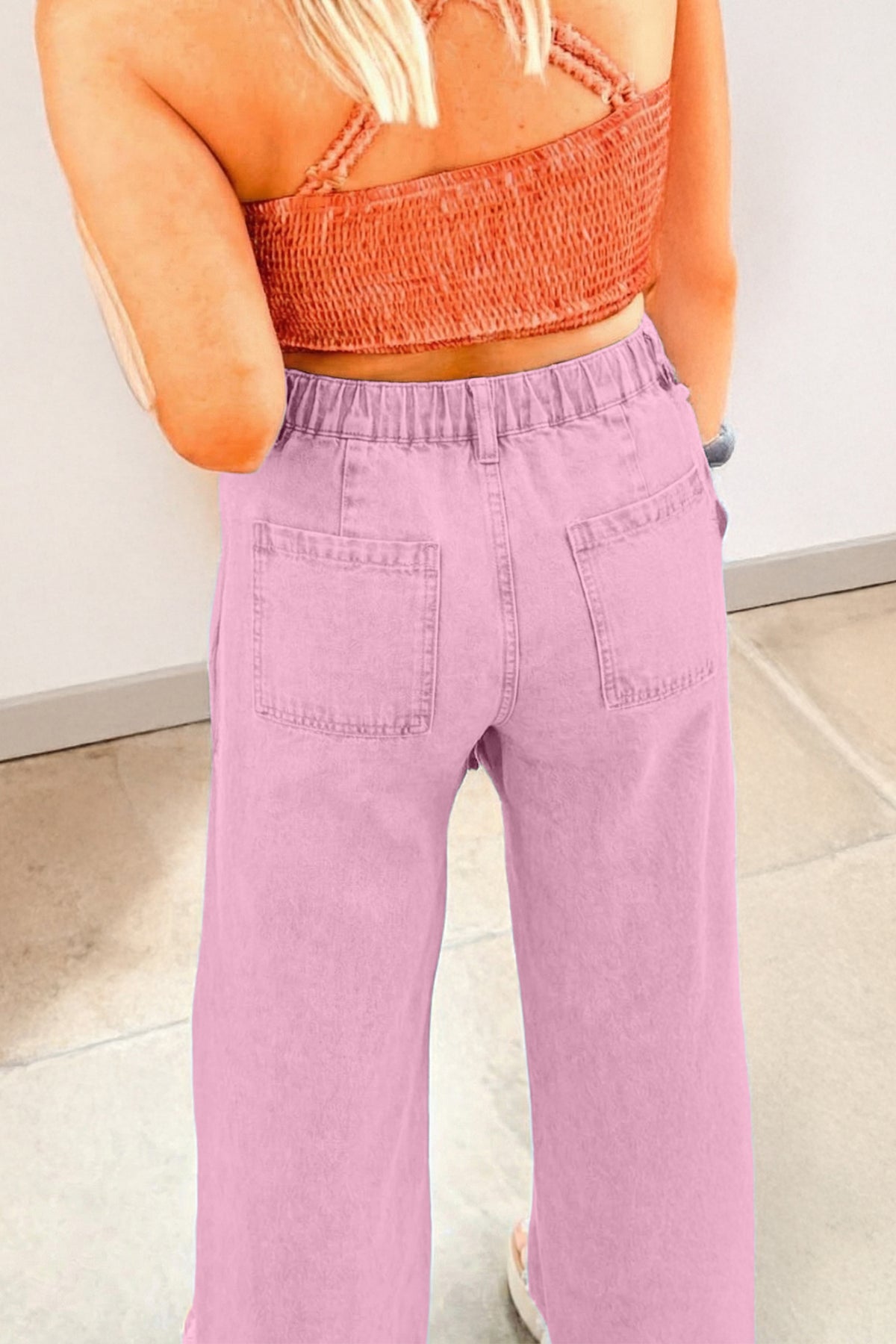 High waisted pink wide leg jeans side view showing beaded seam