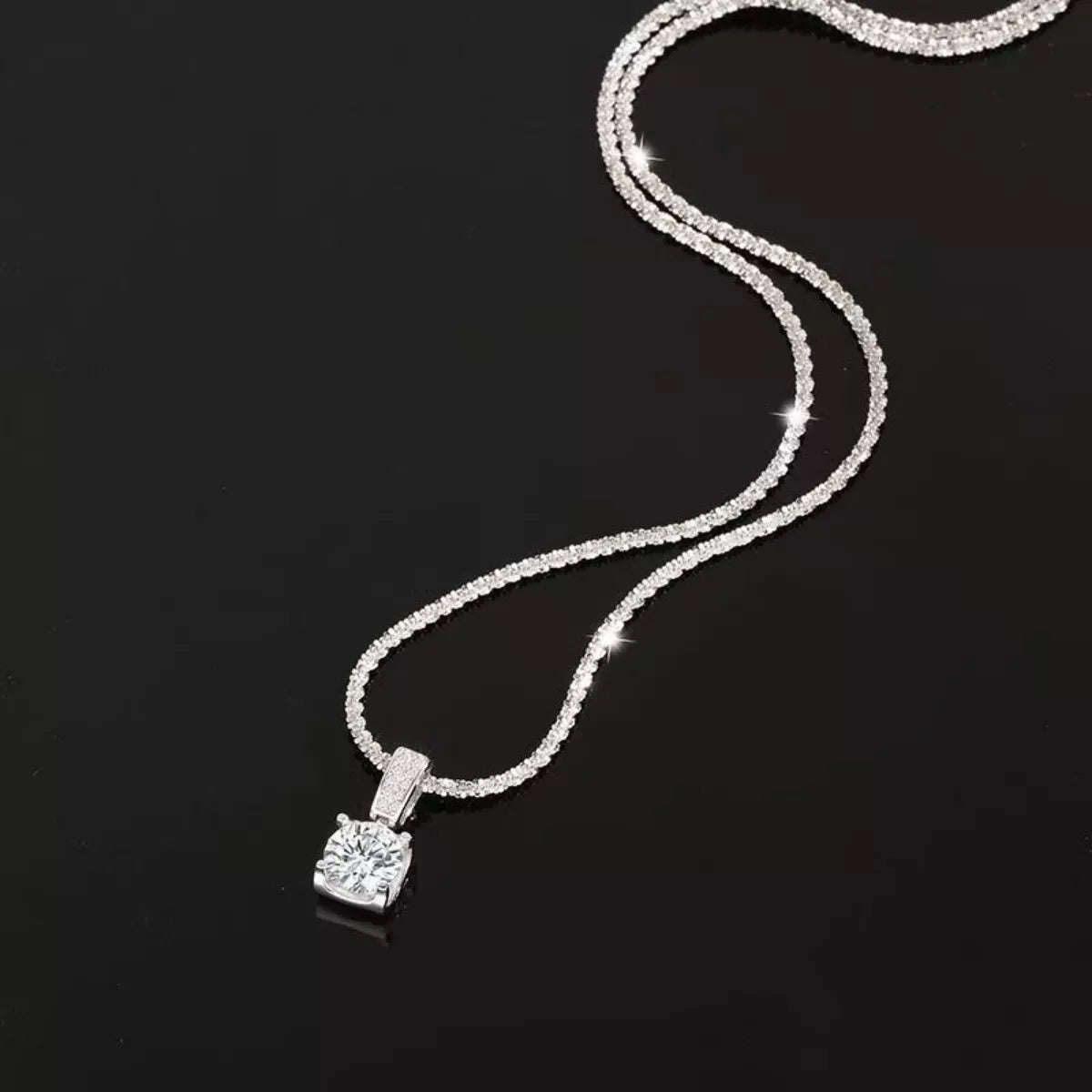 Moissanite solitaire stone close up on the silver necklace