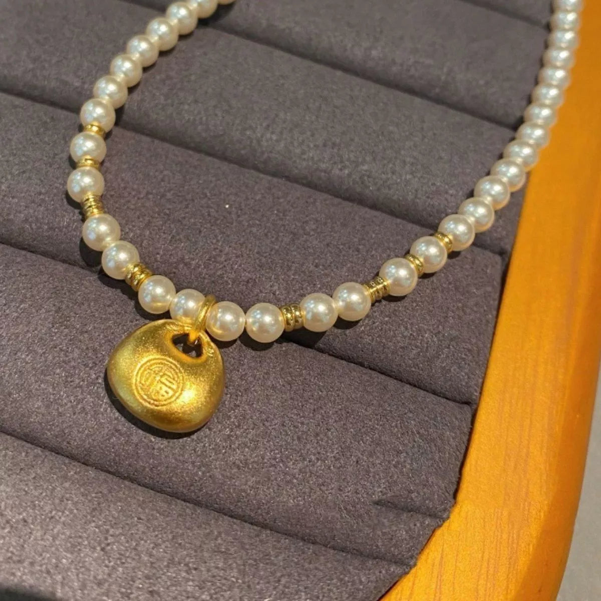 pearl necklace with gold pendant close up detail