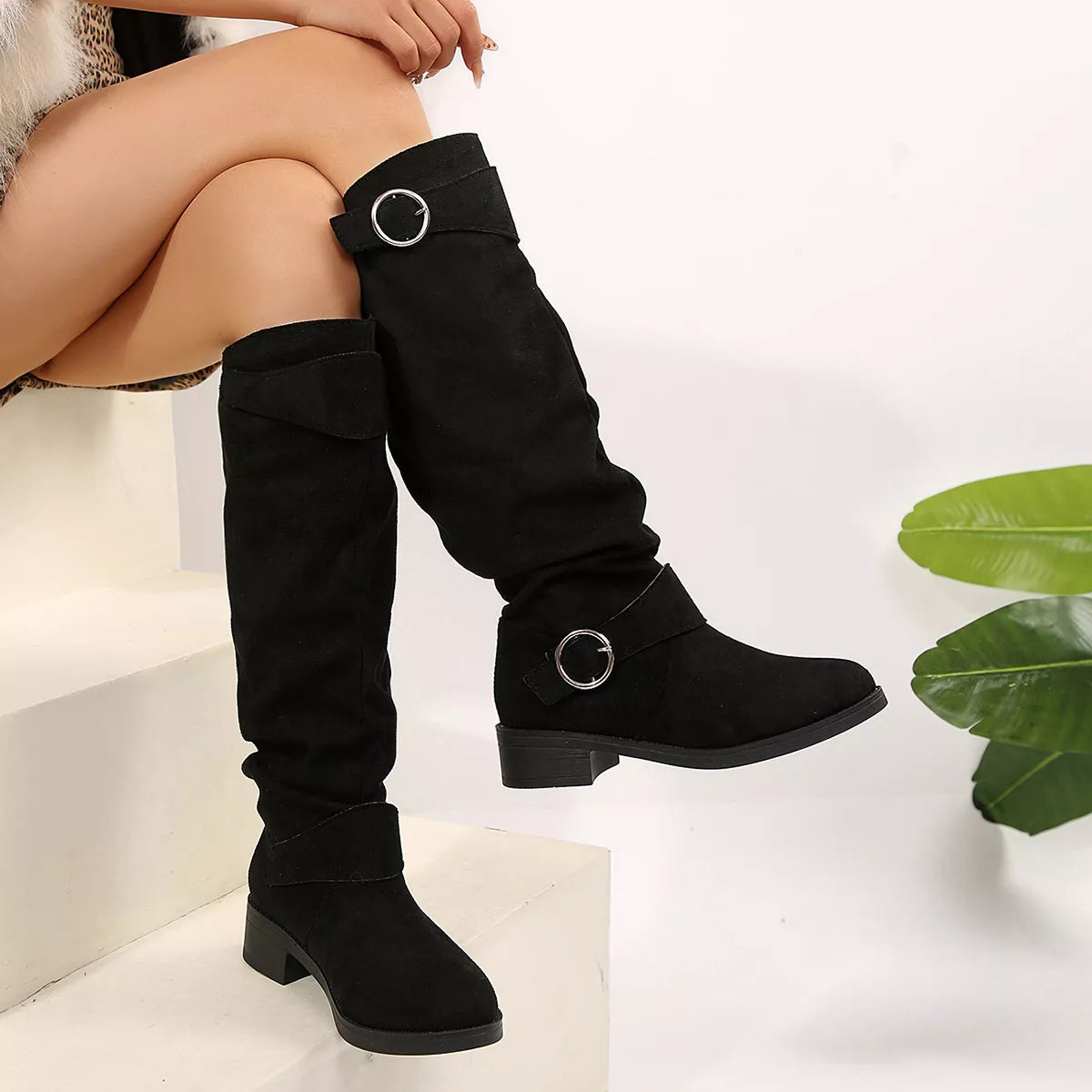 Blue buckle accent slouch boots front facing view