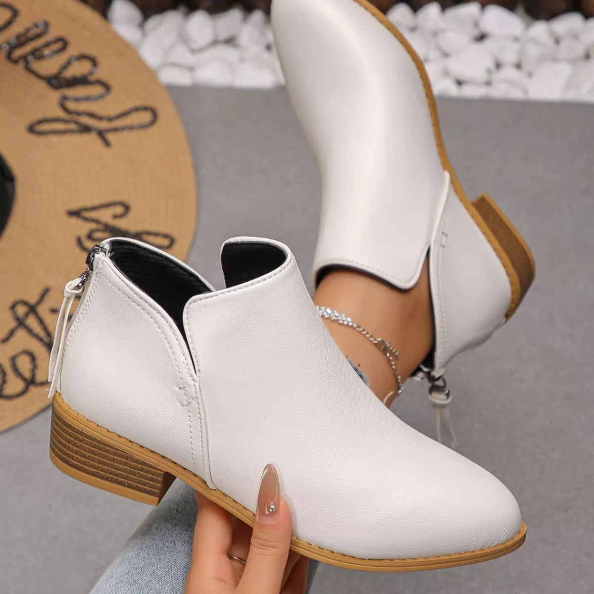 Point toe block heel ankle boots worn on model