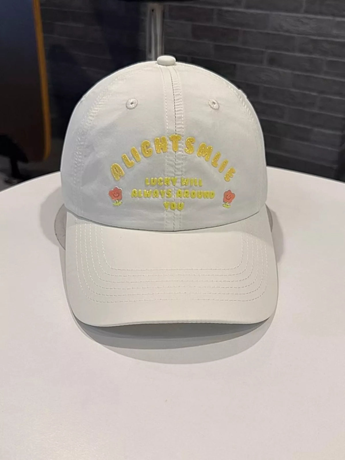 Embroidered cotton cap shown in a neutral colorway