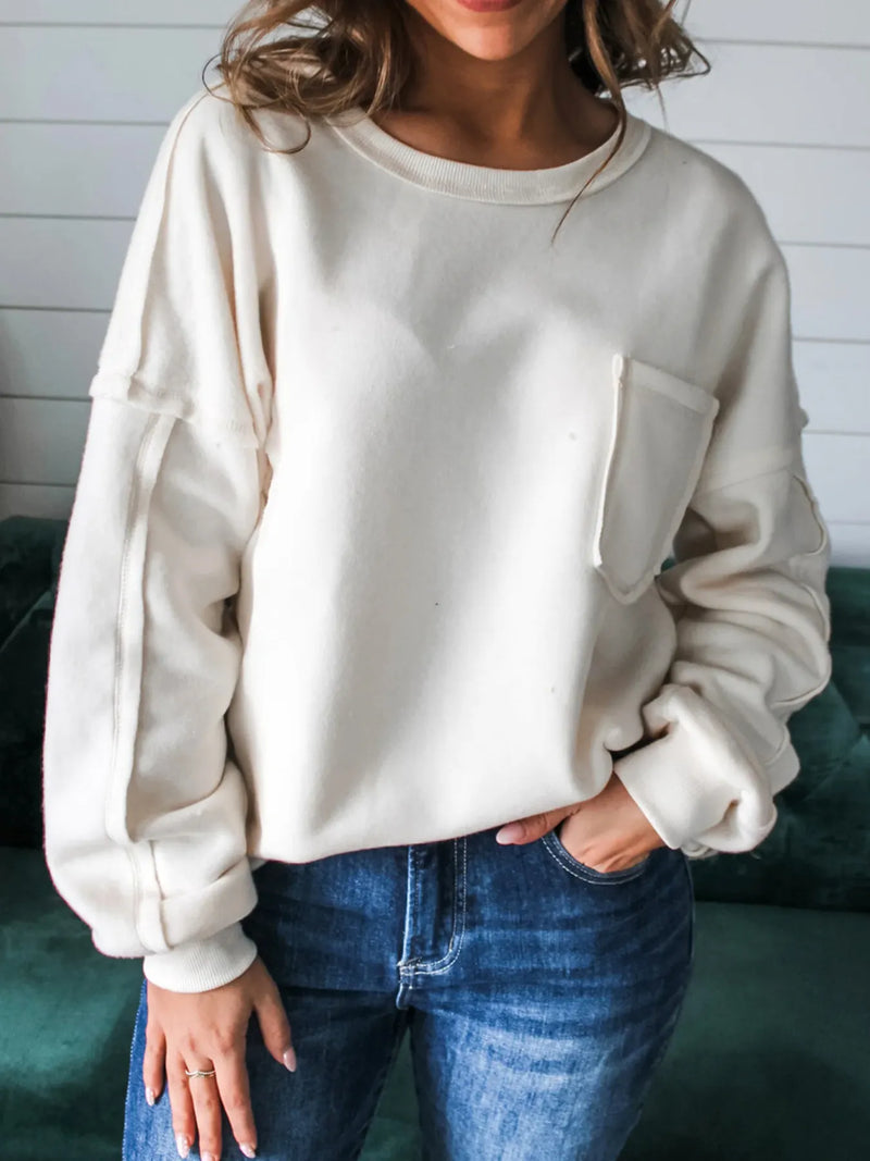 White exposed seam knit pullover front view