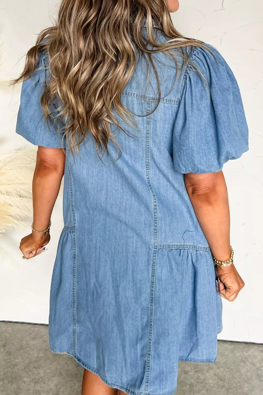 light wash puff sleeve ruffle hem denim dress styled on model