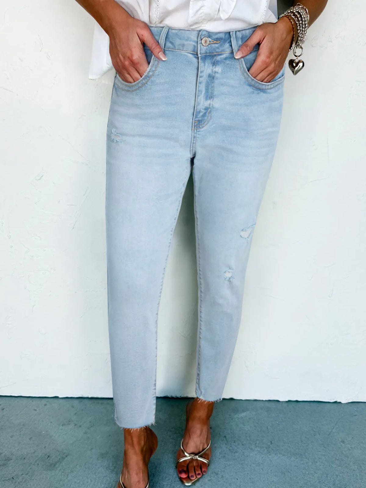 Mid rise distressed skinny jeans in light blue front view