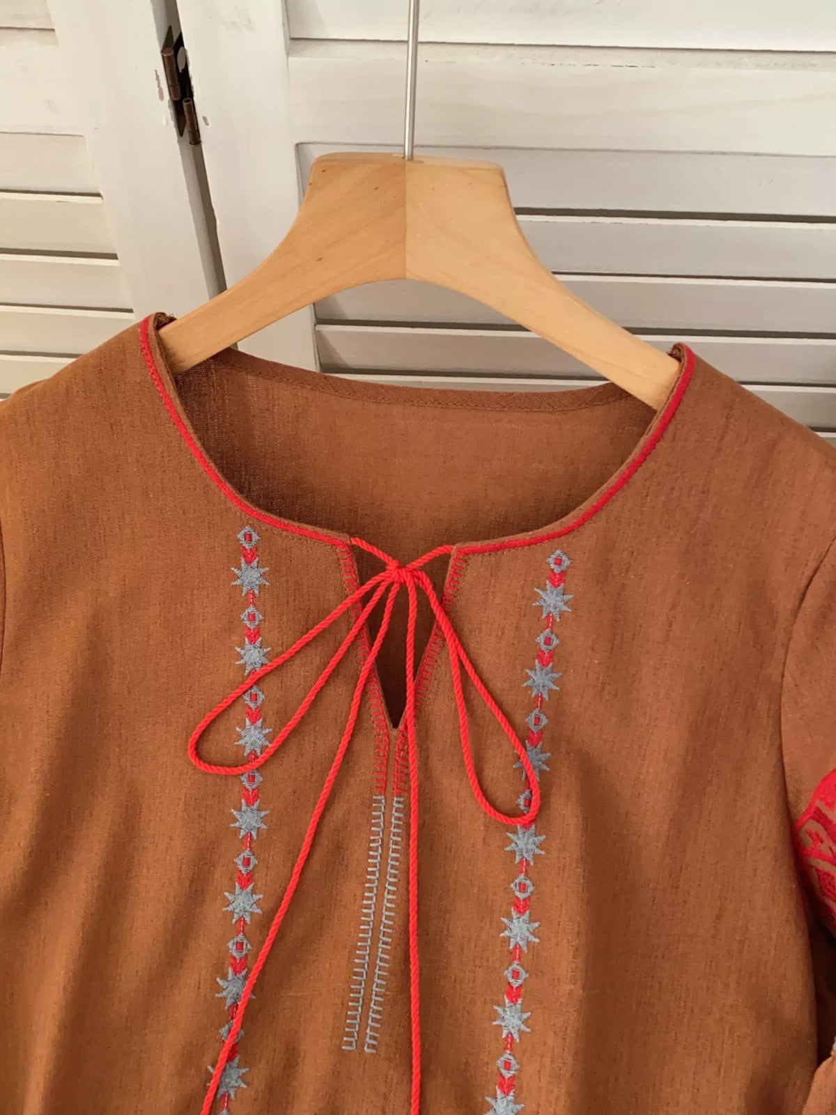 Embroidered tie neck blouse close up view