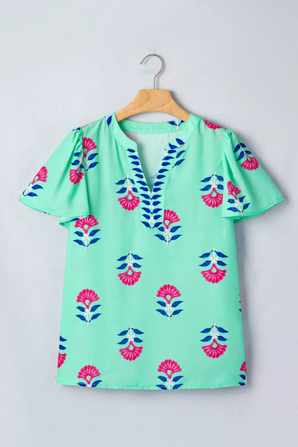 Turquoise floral V neck flutter sleeve blouse detail view