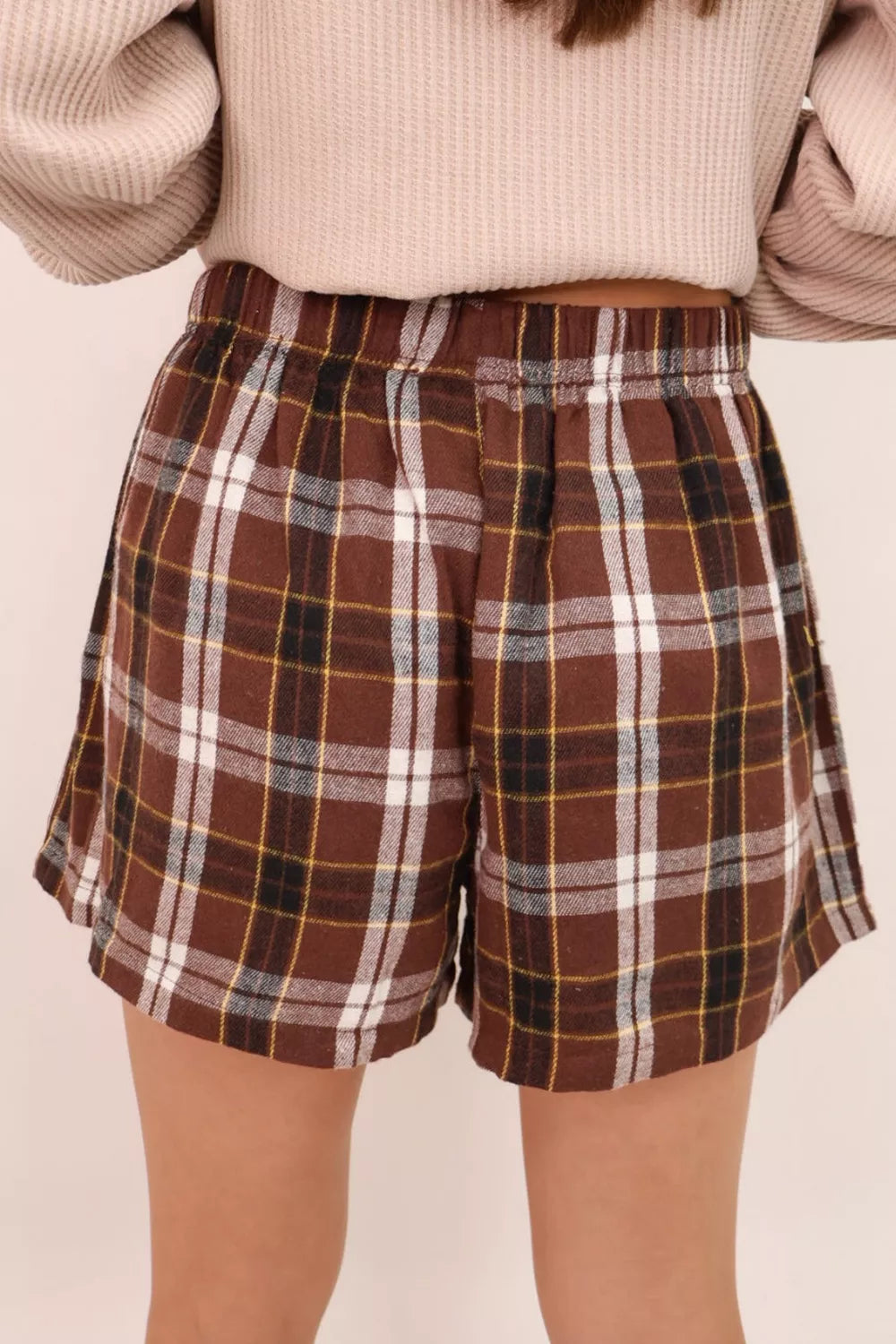 Plaid shorts with elastic waist shown on a model