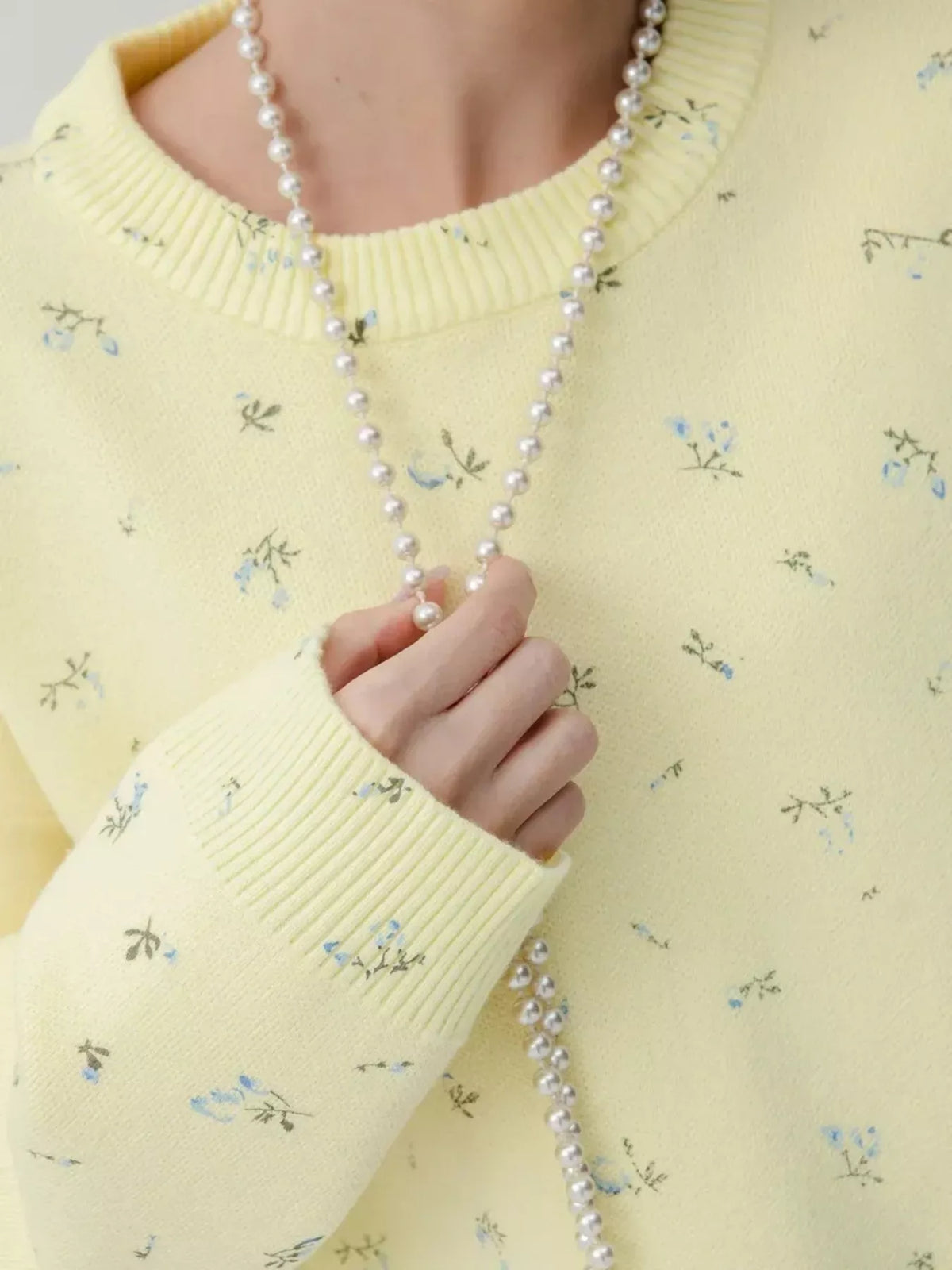 ribbed hem floral long sleeve sweater seated styling view